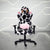 Front view of the techni sport cow gaming chair in black and white in a white room with grey floor. This cow print gaming chair features a black base. The cow chair headrest pillow has light brown horns and ears lined with fluffy pink material and the lumbar pillow has matching fluffy pink to compliment the design. This is definitely one of the cutest Techni Sport Gaming chair options and a great option for cute gaming setups or home office setups. #black