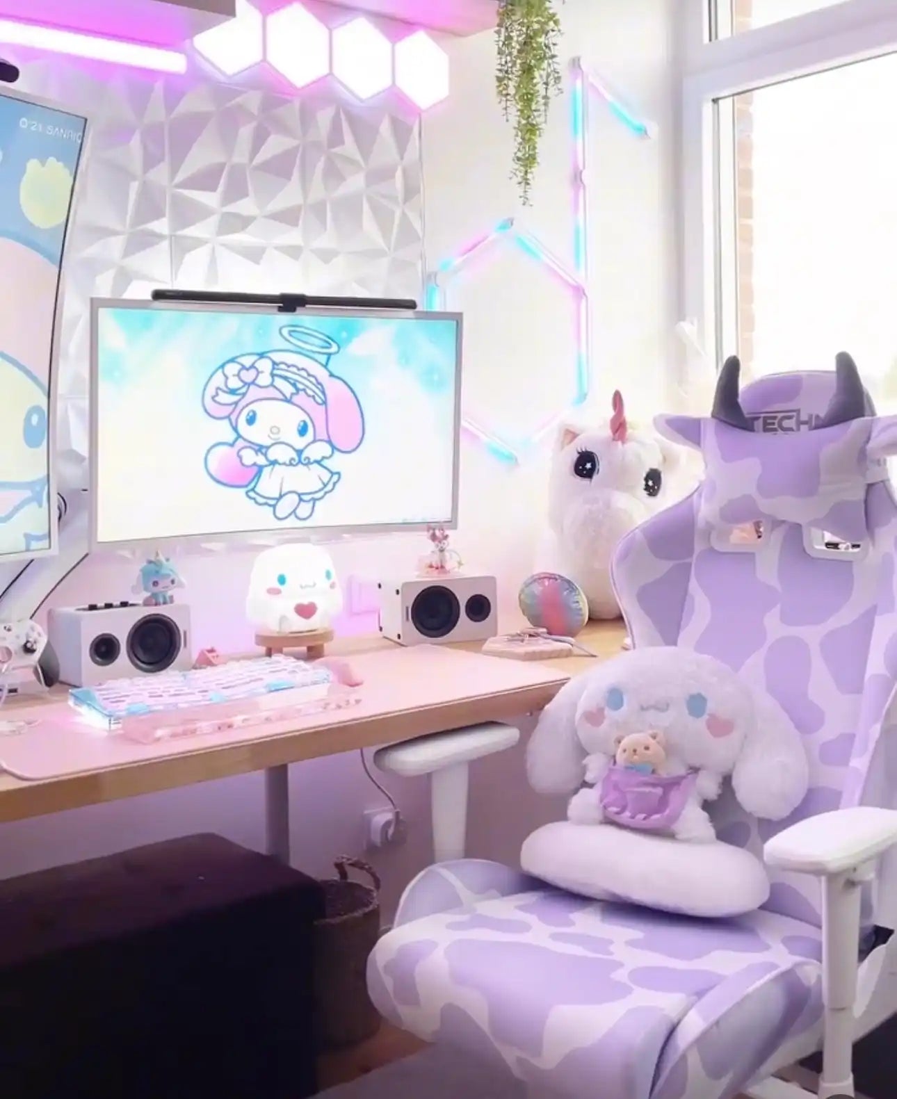 A pastel purple and white cow-print gaming chair with horn accents.