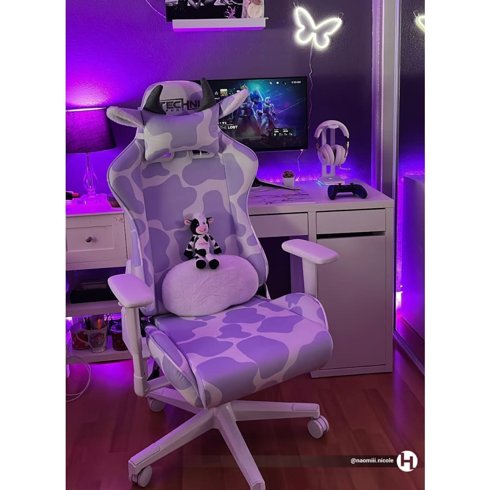 Purple gaming chair in a cute purple gaming setup by @naomiii.nicole. The lavender cow gaming chair on full display with a cute technisport cow plushy sitting on the chair. 