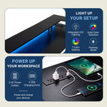 A promotional product graphic for a black desk lamp with integrated LED lighting and USB charging ports. The top panel shows the lamp illuminated with blue light, and the bottom panel shows it plugged into a wall outlet with a tablet and phone charging. 