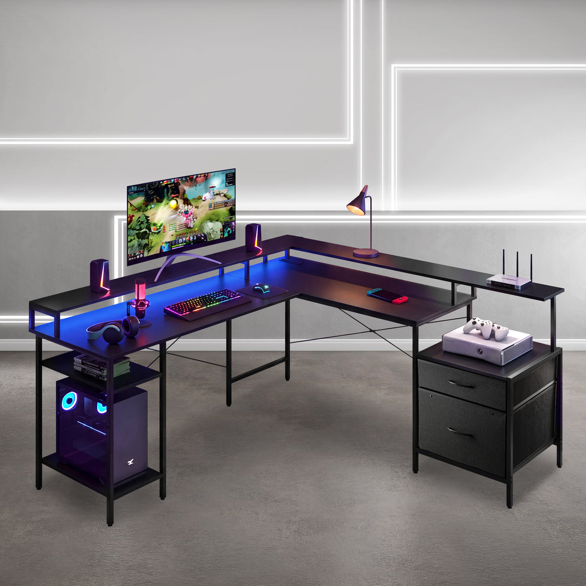 An L-shaped gaming desk with a black frame and a glowing blue LED under-glass desktop surface, styled with a computer tower, monitor, keyboard, lamp, and accessories in a modern room setting. 