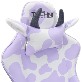 Close up of the cow gaming chair in lavender. this purple gaming chair has a cow pillow headrest with textured grey horns and ears that pop out with a fluffy white lining. The techni sport logo is embroidered in gy. rey