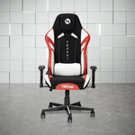 A black, red, and white gaming chair with a headrest pillow and lumbar support cushion.