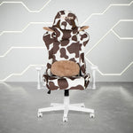 Cow print gaming chair with white base and brown lumbar pillow.