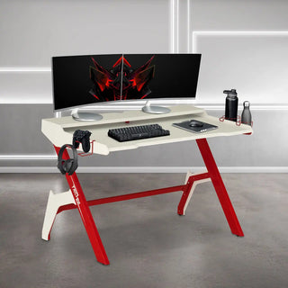 Gaming desk with monitor and accessories.