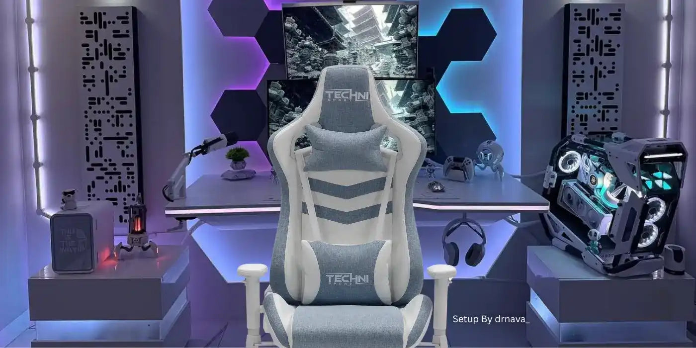 A grey and white gaming chair with lumbar and headrest pillows.
