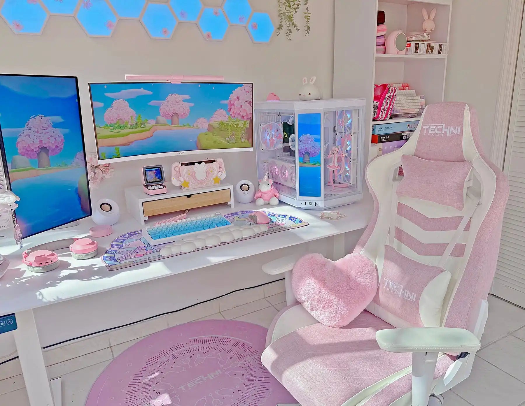 A pink and white gaming chair with plush cushions.