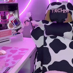 close up of cow print gaming chair in an LED lit gaming setup 