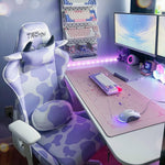 Gaming setup with a cow-patterned chair, dual monitors, and colorful peripherals. 