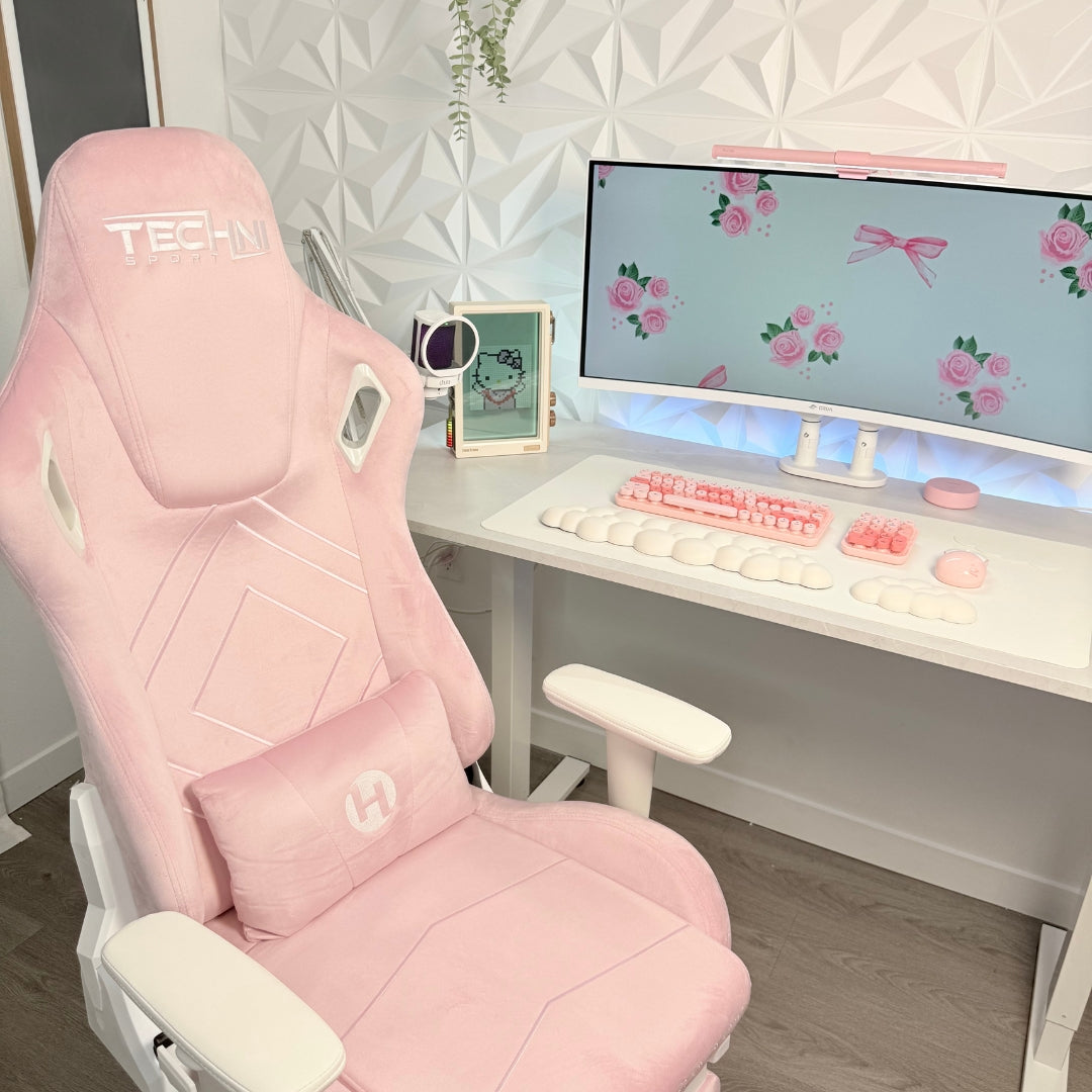 Pink gaming chair in a room with a desk and computer setup.